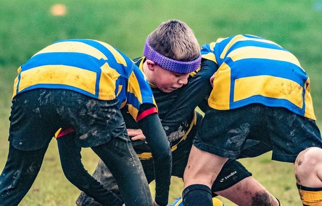 A youth rugby player wearing Rezon Halos® brain protection.